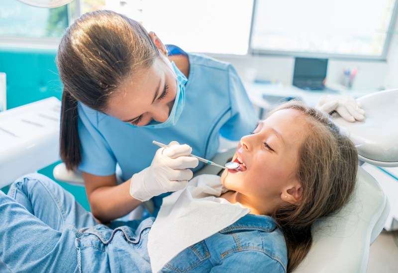 Dentist performing cosmetic dental bonding treatment in Plainfield, IN