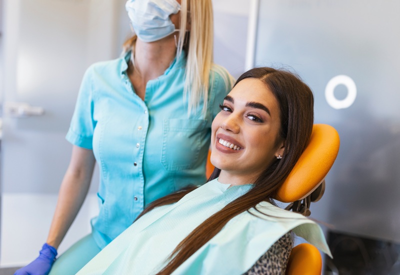 Happy patient in chair after dental care in Plainfield, IN