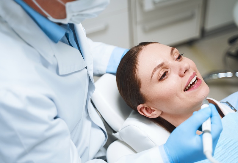 After root canal, dentist in Plainfield, IN examines patient’s teeth.