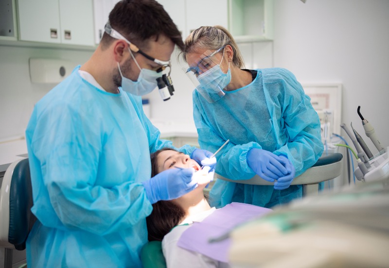 Dentist and assistant perform root canal in Plainfield, IN