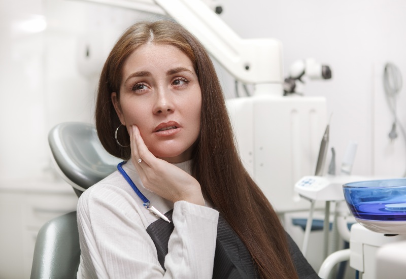 Patient with toothache seated in dental chair in Plainfield, IN